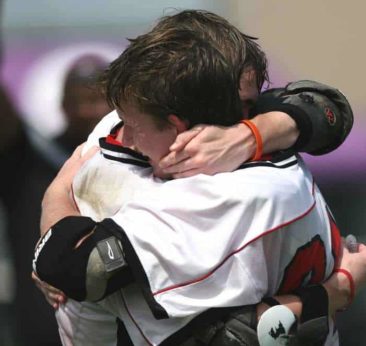 Two lacrosse players celebrate a victory. {{brizy_dc_image_alt imageSrc=